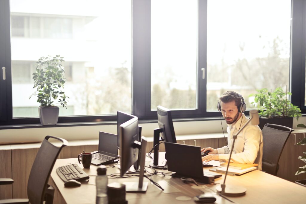 Male working at his desk, in front of window